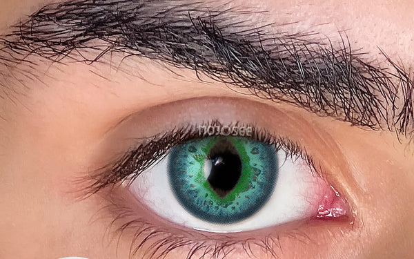 Green cosplay contact lens on an open eye