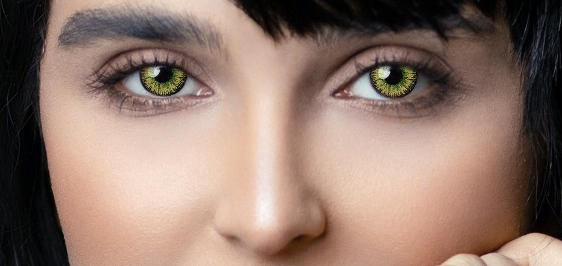 Green colored contacts on a short-haired model, editorial close-up