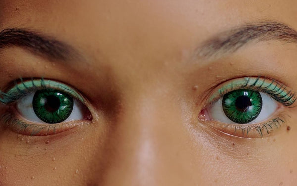 Close-up of eyes wearing green colored contacts with natural iris texture