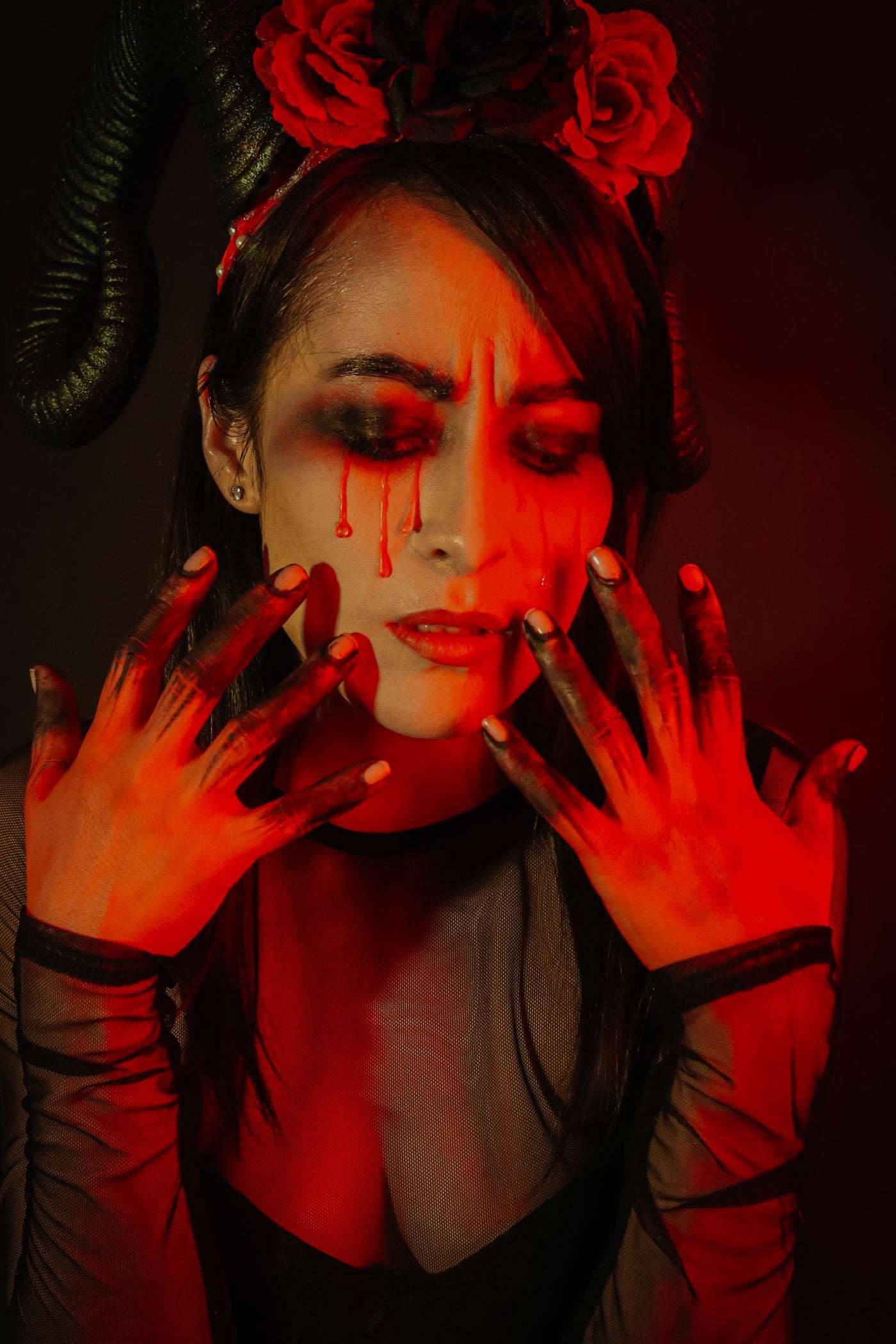Gothic portrait of a woman with horns and dramatic dark makeup