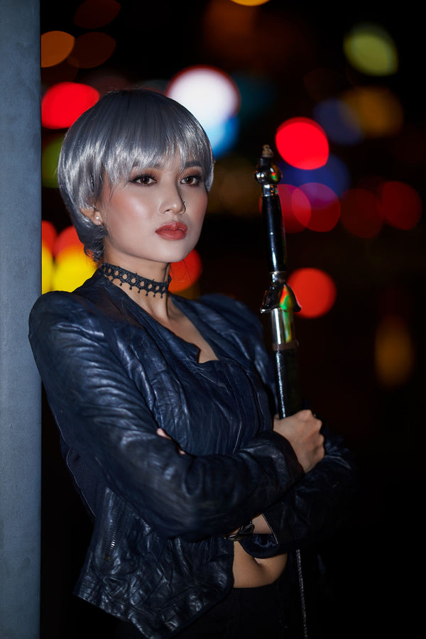 Model in dramatic leather costume posing with a sword