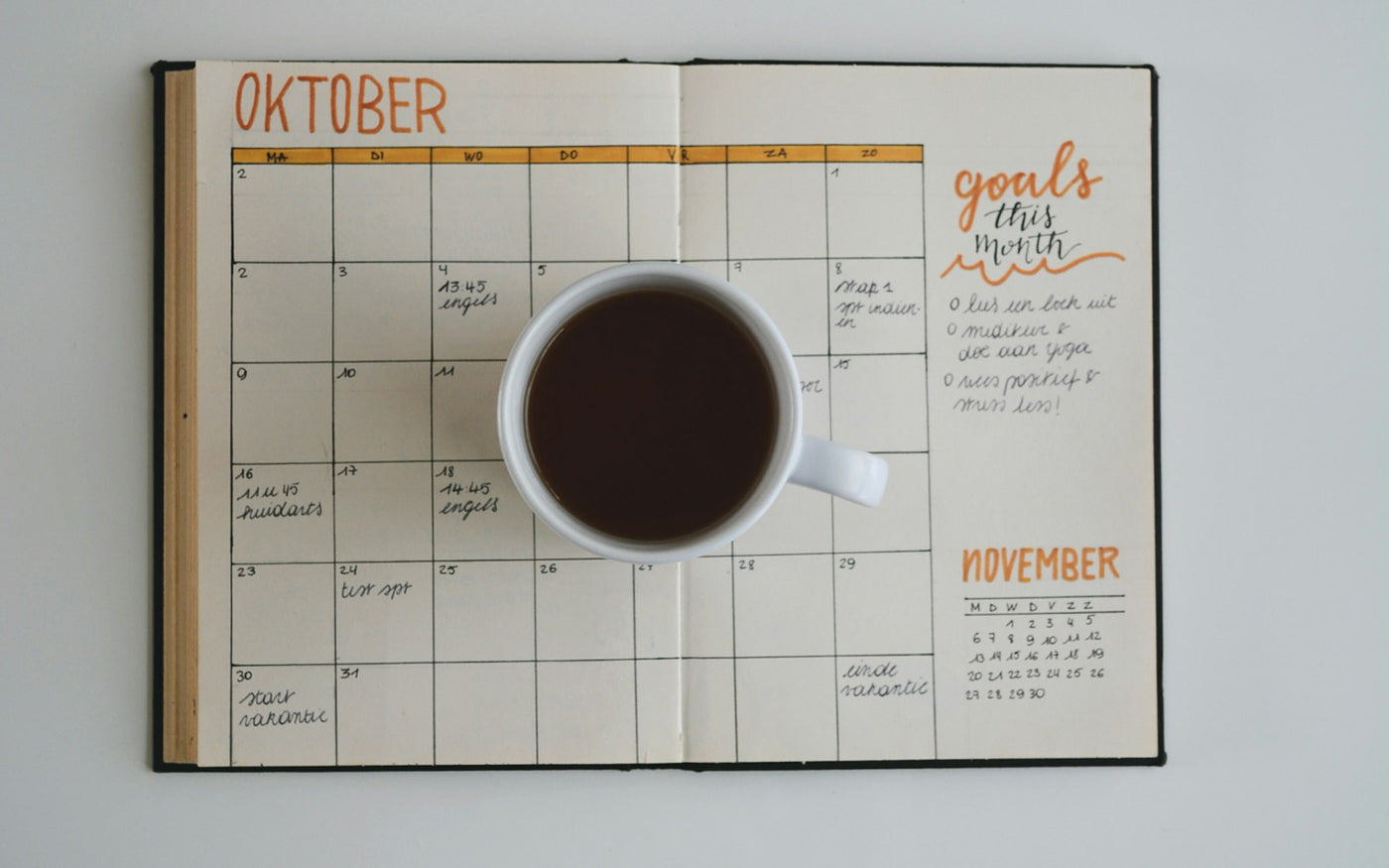 monthly calendar planner with a cup of coffee