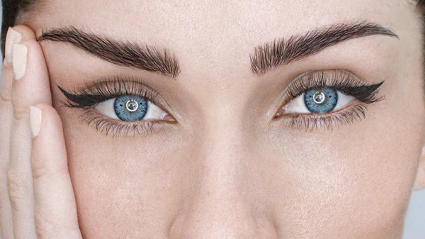 Blue colored contacts close-up with graphic liner