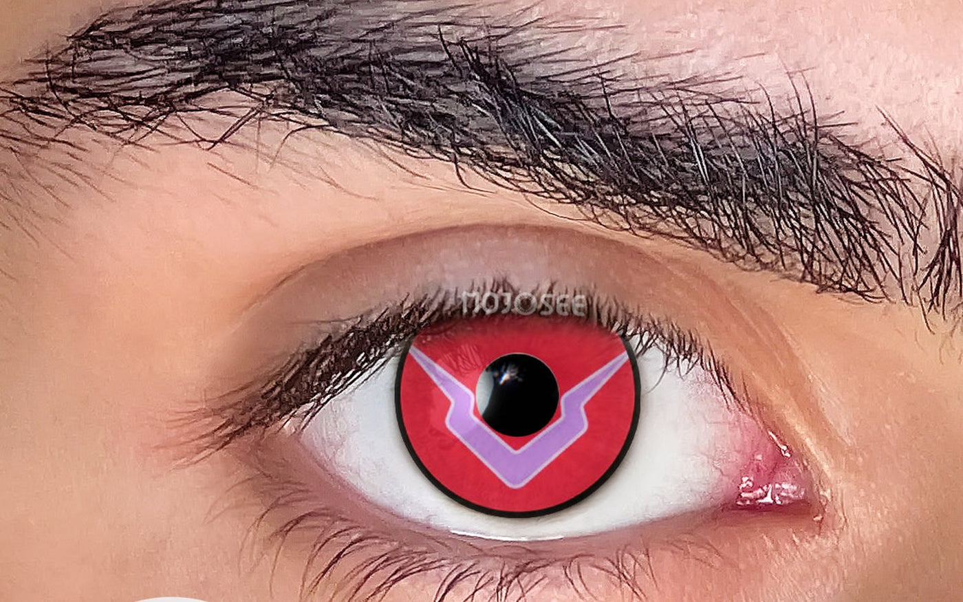 Red geometric cosplay contact lens on an open eye