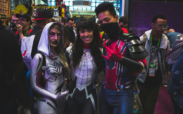 group of cosplayers posing together at a convention