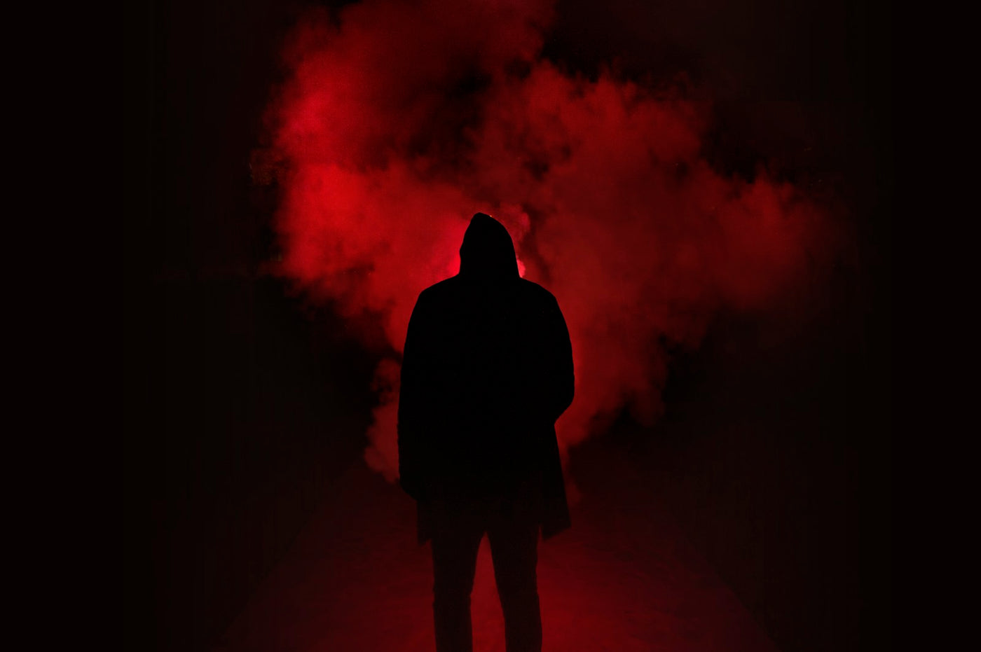 Dark hooded silhouette in red smoke, moody cosplay atmosphere