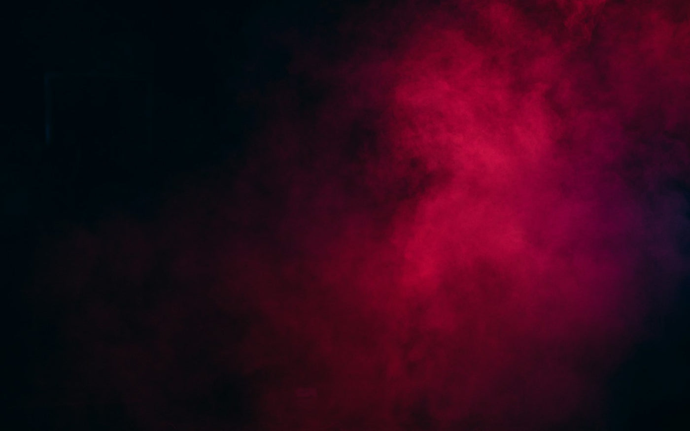 crimson smoke billowing against a black background