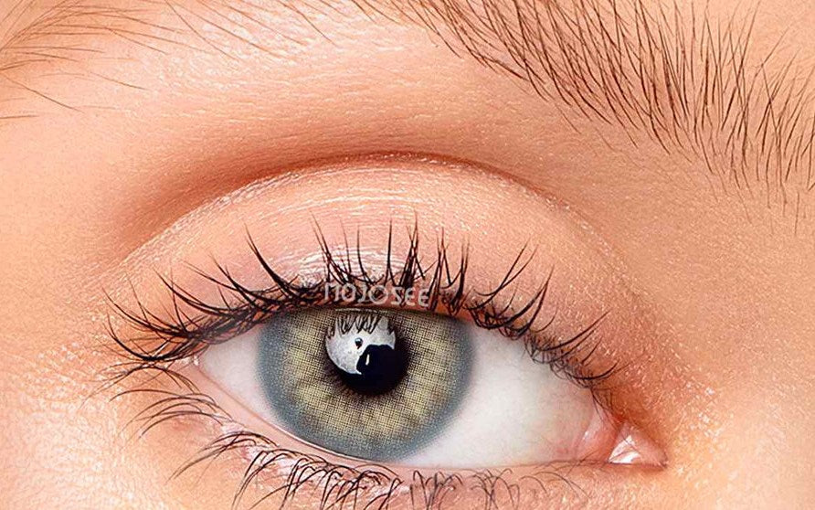 Blue-gray lens worn on a real eye in daylight