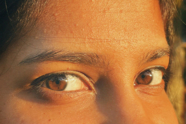 Close-up of expressive natural brown eyes in sunlight