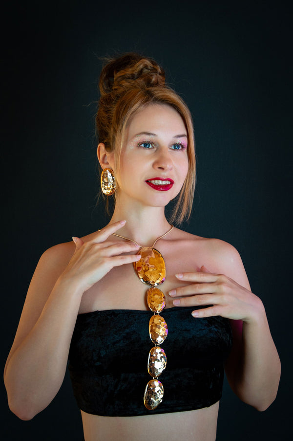 Woman in evening attire wearing elegant gold jewelry