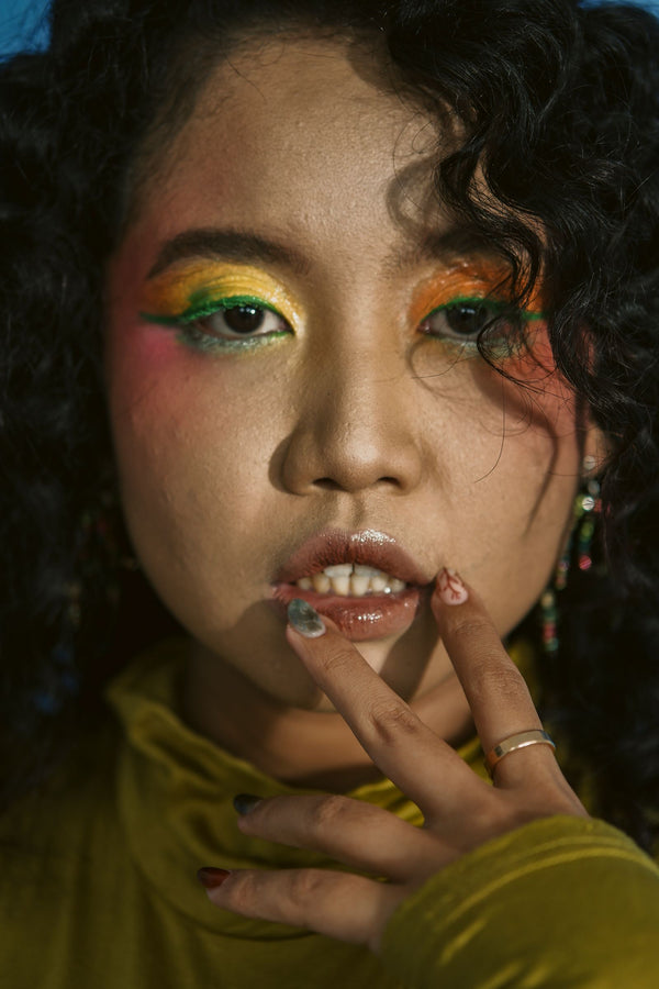 Woman with colorful eye makeup showing different eye-color looks