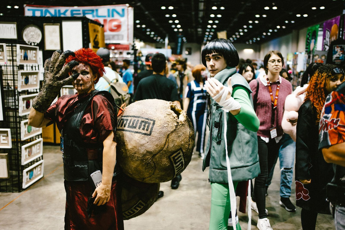 Cosplayers dressed as anime characters on a bustling convention floor