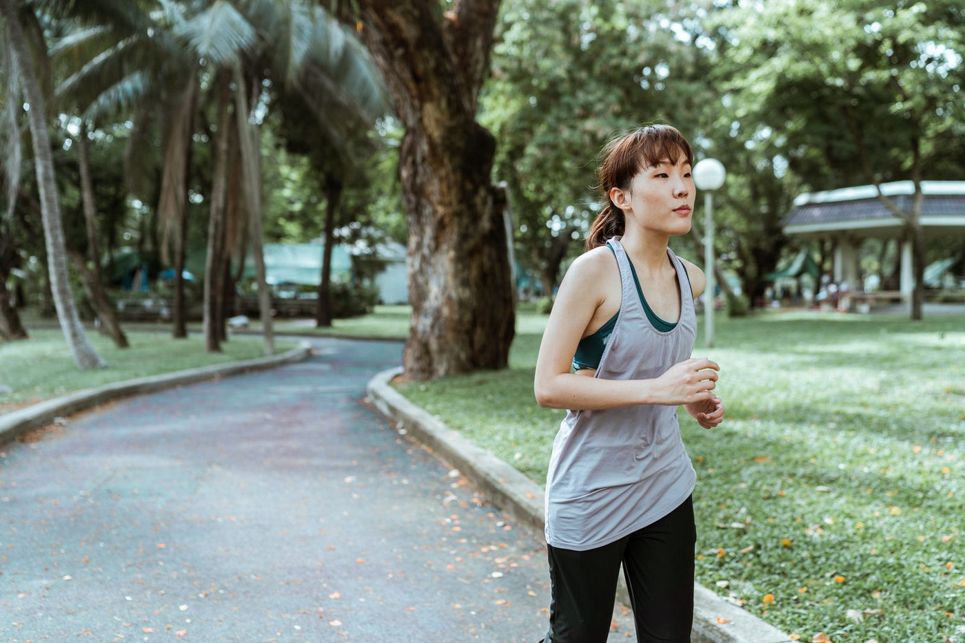 Female athlete in sportswear running outdoors