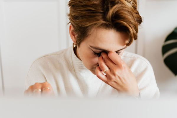 Close-up of a woman rubbing her irritated eyes