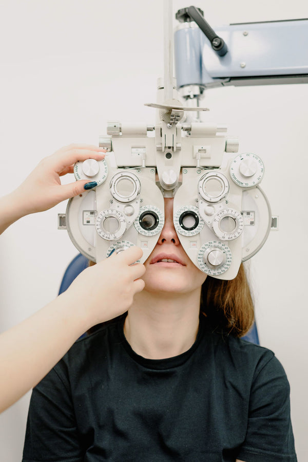 Ophthalmologist using professional phoropter equipment