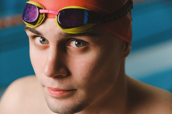 Close-up of a swimmer wearing goggles and a swim cap at the pool