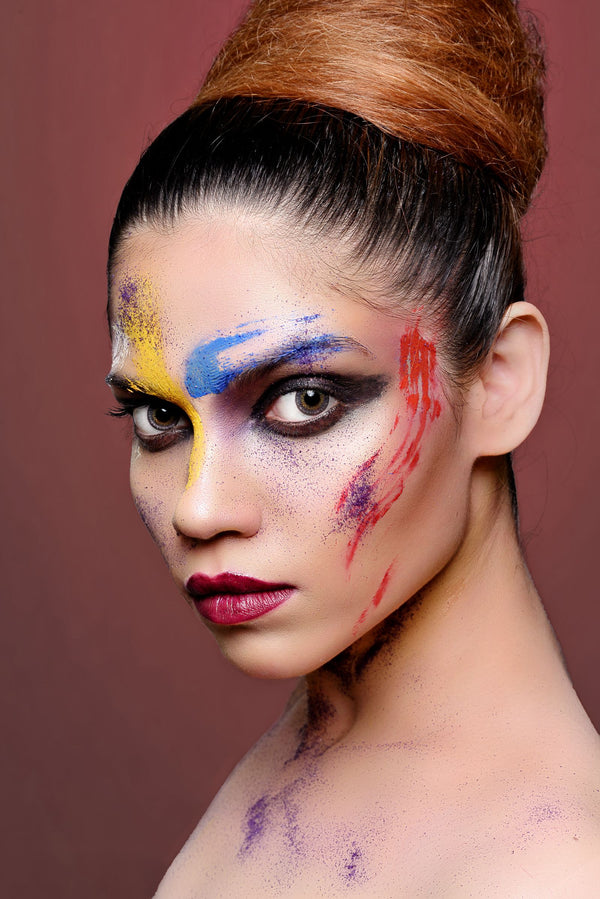 Model with bold artistic eye makeup in vivid colors